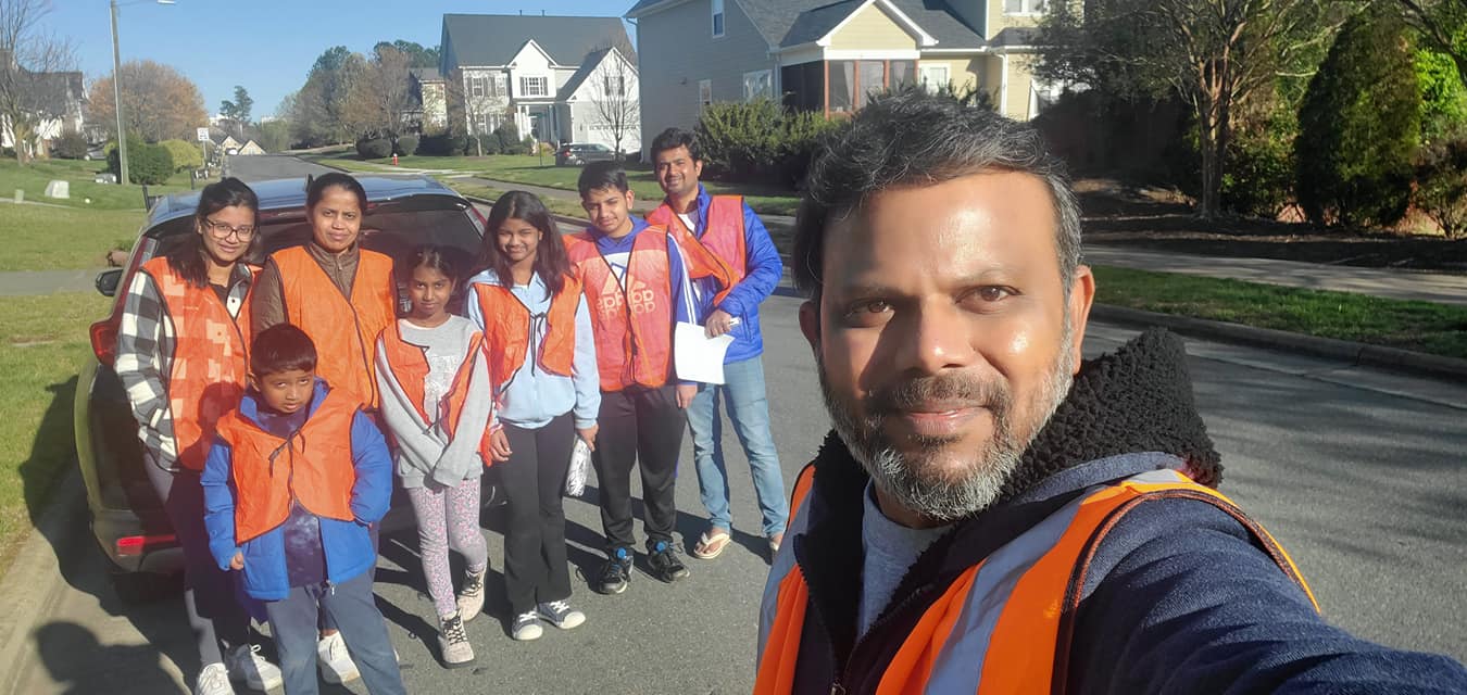 group photo of stormdrain marking team in orange vests